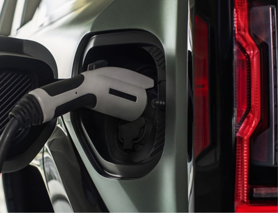 Close up of charging port with charger plugged in on a GMC Hummer EV SUV - Don Johnson Motors GMC in Rice Lake WI