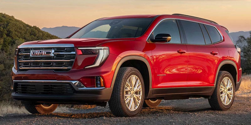 Red GMC Acadia 2026 midsize SUV parked outdoors at Don Johnson Motors GMC Rice Lake, WI