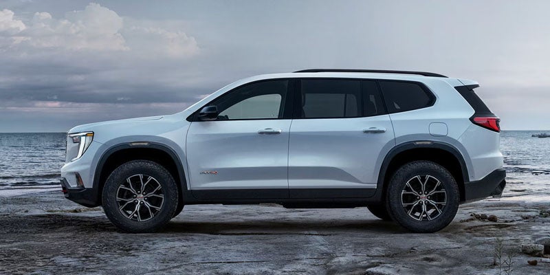 Side profile of white 2026 GMC Acadia SUV Rice Lake, WI at Don Johnson Motors GMC