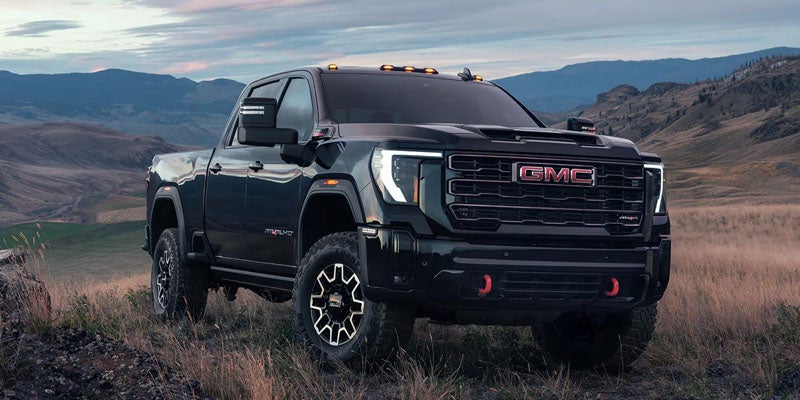 Black GMC Sierra 2500 HD heavy-duty truck parked outside dealership at Don Johnson Motors GMC Rice Lake, WI